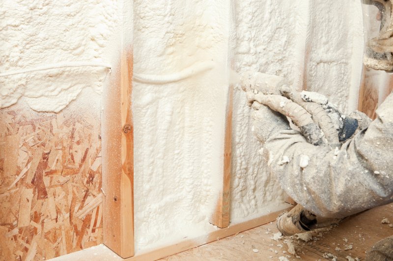 Workers installing spray foam insulation (Photo by Banks Photos/E+ via gettyimages.com)